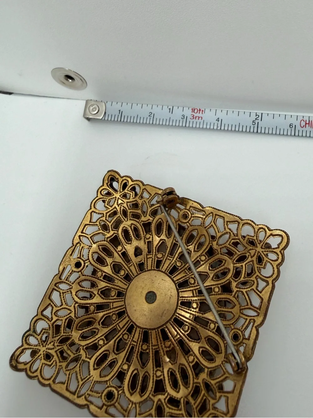 Victorian style filigree gold tone milk glass brooch